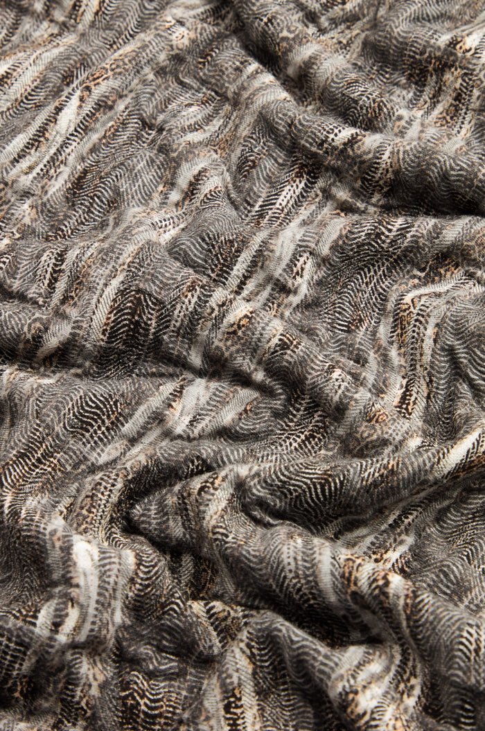 Close-up of the Abstract Ripple Jersey Boxy Top, showcasing its textured, crumpled fabric with a black, white, and brown pattern of wavy and dotted lines.