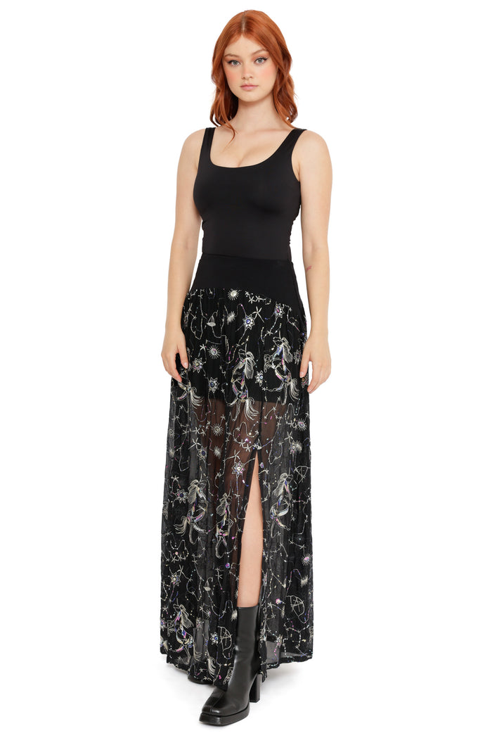 Sheer black maxi skirt with celestial constellation embroidery, featuring stars, moons and a front slit