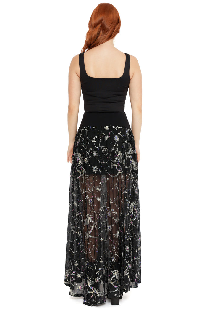 Black sheer skirt with constellation and star embroidery, designed with a high waist and dramatic split