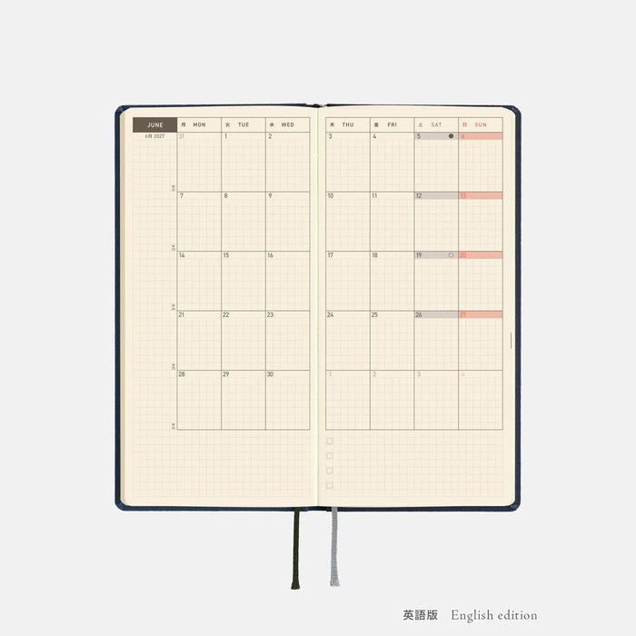 Opened 2027 planner spread with weekly chart grids and red highlights