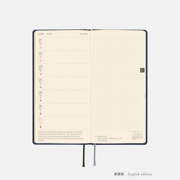 Opened dark blue 2027 planner showing calendar layout pages