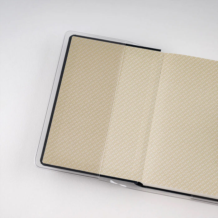 Hobonichi Techo HON A6 clear cover, open over patterned pages
