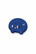 Small embroidered pin, blue speech-bubble face with white eyes