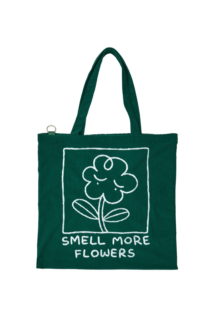 Green tote bag with embroidered flower and 'SMELL MORE FLOWERS' front