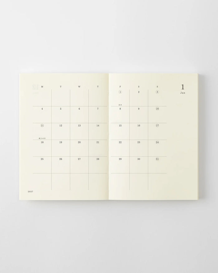 MD 2027 monthly planner notebook open to month calendar grid with dates