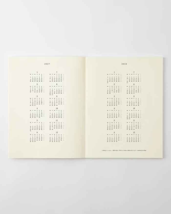 MD monthly calendar pages in an open notebook, dot grid layout for planning