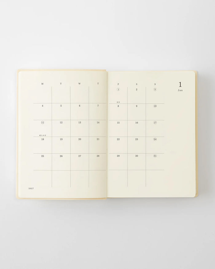 Open planner calendar spread with daily date blocks