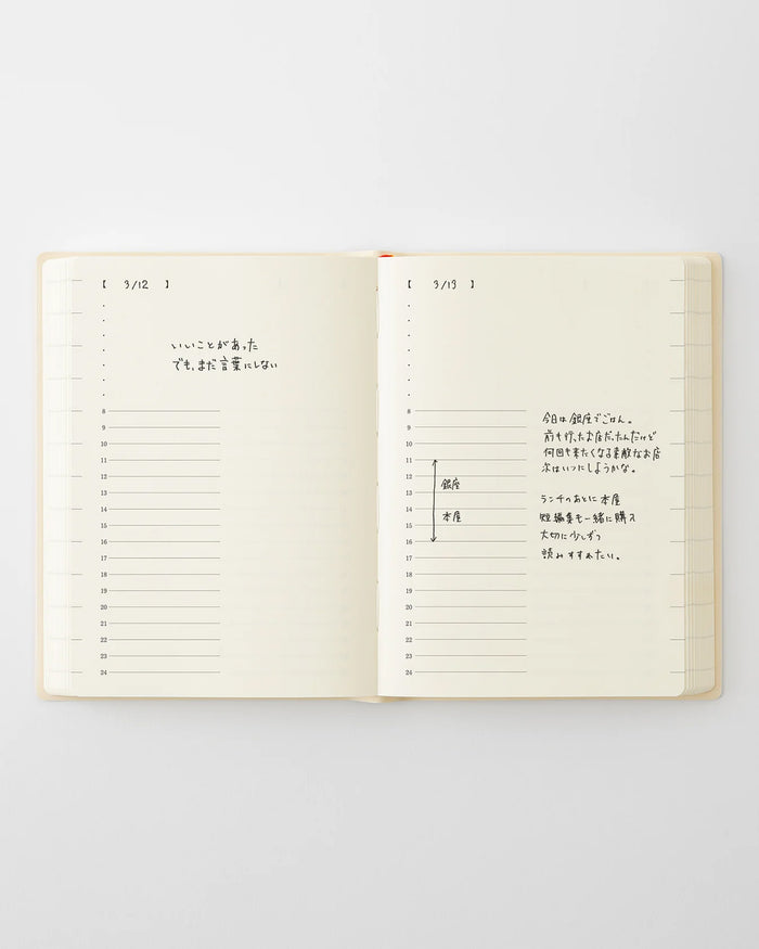 Open page-a-day planner with handwritten notes on dated daily lines