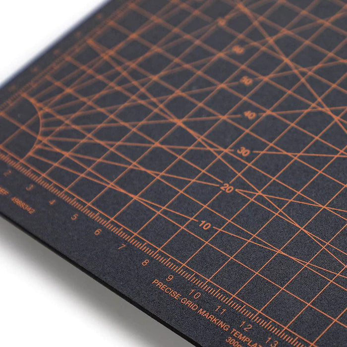 Close-up of dark A5 cutting mat with orange crosshatch grid