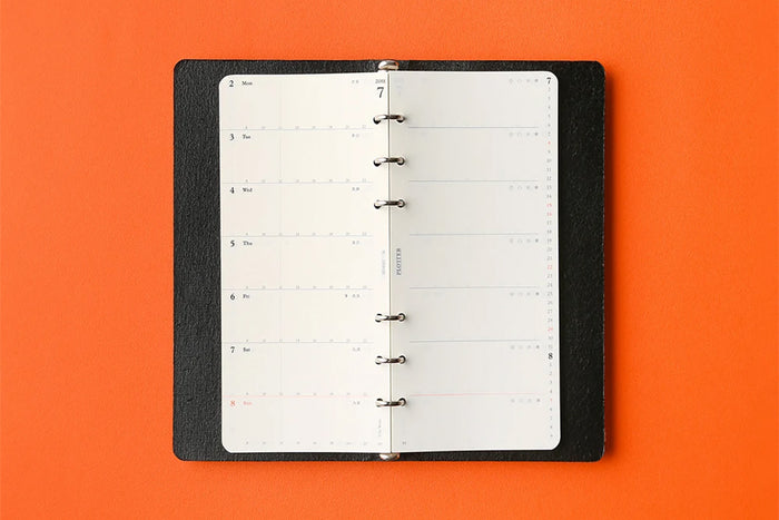 Open narrow weekly schedule refill on ring binder, punched pages visible