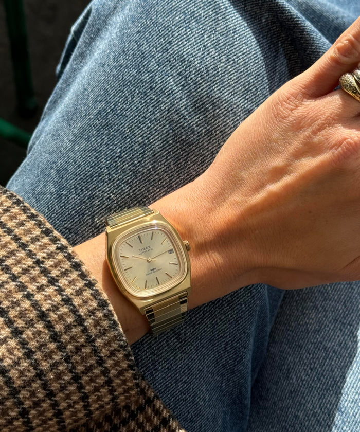 TW2Y07200 Timex® Automatic 1983 E Line Reissue 34mm Gold-Tone Expansion Band Watch Primary Wrist Image
