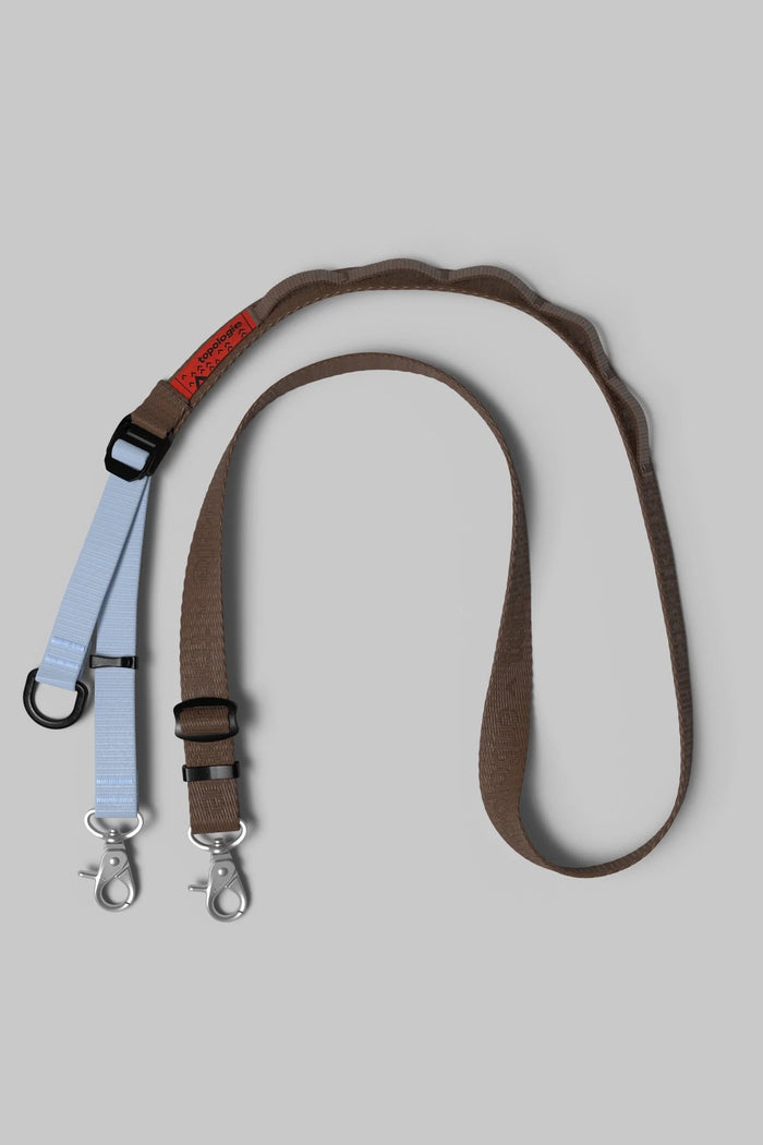 Utility sling with adjustable brown strap and metal clip hardware